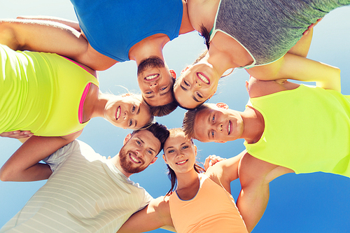 fitness, sport, friendship and healthy lifestyle concept - group of happy teenage friends or sportsmen in circle outdoors