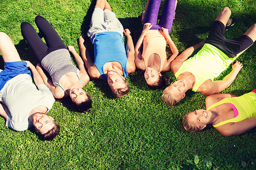 fitness, sport, friendship and healthy lifestyle concept - group of happy teenage friends in circle outdoors