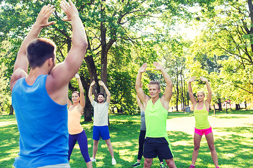 fitness, sport, friendship and healthy lifestyle concept - group of happy teenage friends or sportsmen exercising at boot camp