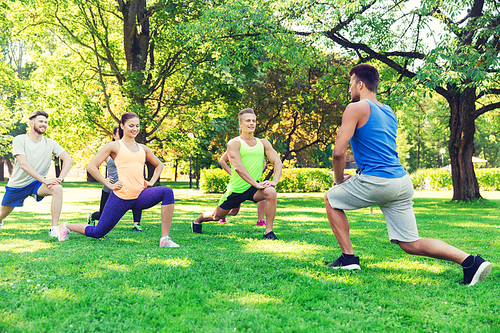 fitness, sport, friendship and healthy lifestyle concept - group of happy teenage friends or sportsmen exercising and doing lunge at boot camp