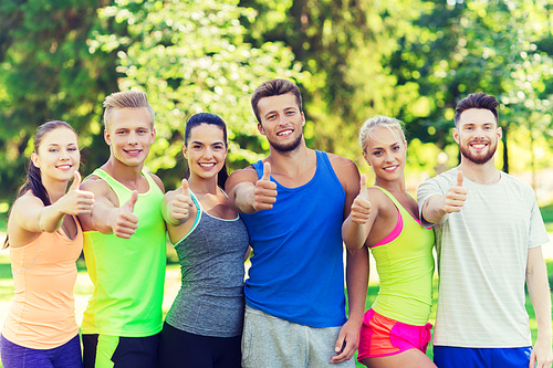 fitness, sport, friendship and healthy lifestyle concept - group of happy teenage friends or sportsmen showing thumbs up outdoors