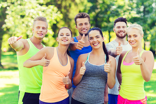 fitness, sport, friendship and healthy lifestyle concept - group of happy teenage friends or sportsmen showing thumbs up outdoors