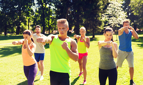 fitness, sport, martial arts, self-defense and healthy lifestyle concept - group of teenage friends or sportsmen exercising and at boot camp