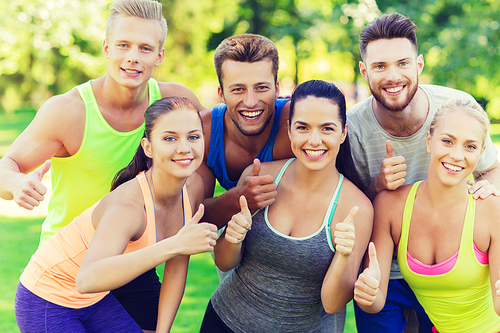 fitness, sport, friendship and healthy lifestyle concept - group of happy teenage friends or sportsmen showing thumbs up outdoors