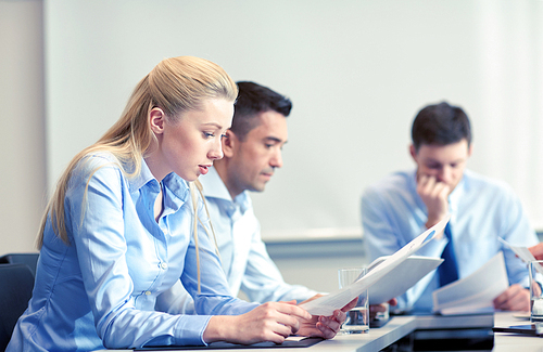 business, teamwork, people and crisis concept - business team sitting sad and solving problem in office