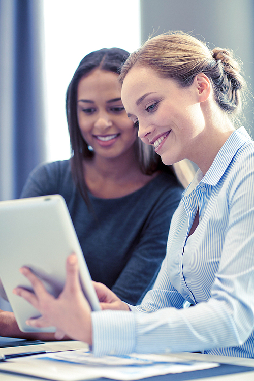 business, people and technology concept - smiling businesswomen with tablet pc computer meeting in office