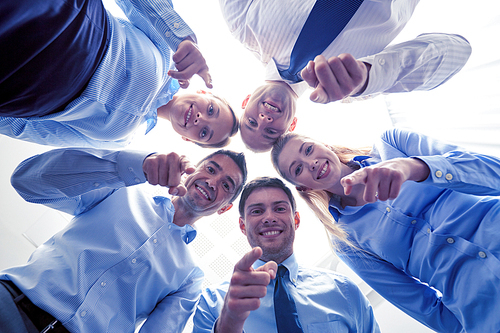 business, people and teamwork concept - smiling group of businesspeople standing in circle