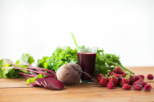 healthy eating, food, dieting and vegetarian concept - glass of beetroot juice, fruits and vegetables on wooden table