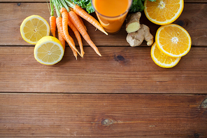 healthy eating, food, dieting and vegetarian concept - glass of carrot juice, fruits and vegetables on wooden table