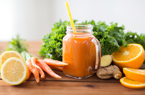 healthy eating, food, dieting and vegetarian concept - glass jug of carrot juice, fruits and vegetables on wooden table
