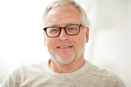 old age, vision and people concept - close up of smiling senior man in glasses