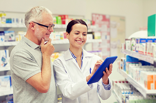 medicine, pharmaceutics, health care and people concept - happy pharmacist with tablet pc computer and senior man customer at drugstore