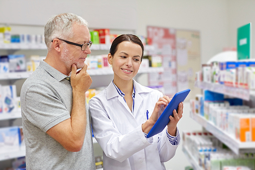 medicine, pharmaceutics, health care and people concept - happy pharmacist with tablet pc computer and senior man customer at drugstore