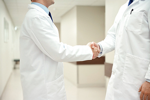healthcare, profession, people and medicine concept - close up of doctors making handshake