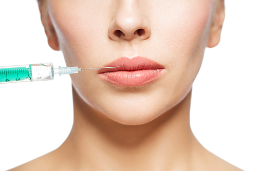 people, cosmetology, plastic surgery and beauty concept - beautiful young woman face and syringe making injection for lips augmentation over white background