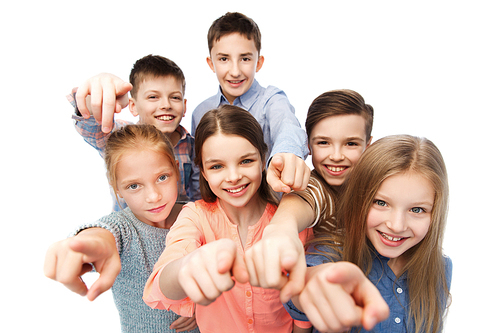 childhood, fashion, friendship and people concept - happy smiling children pointing finger to you