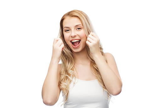 health care, dental hygiene, people and beauty concept - happy young woman or teenage girl with floss cleaning teeth