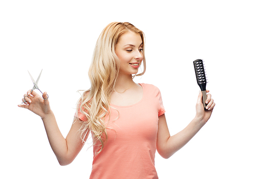 hair care, hairstyle, hairdressing and beauty people concept - young woman or teenage girl with scissors and hairbrush