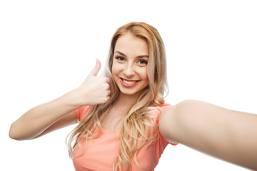 emotions, expressions and people concept - happy smiling young woman taking selfie and showing thumbs up