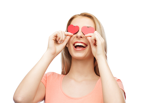 love, romance, valentines day and people concept - smiling young woman or teenage girl with red heart shapes on eyes
