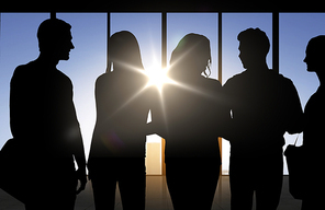business, education and people concept - people silhouettes over office background