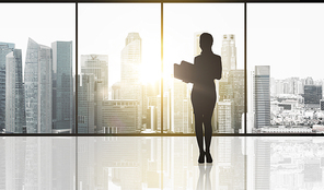 business and people concept - silhouette of woman with folders over office window and singapore city skyscrapers background and sun light