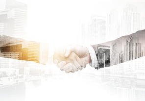 business, people, partnership, gesture and cooperation concept - businessman and businesswoman shaking hands over city with double exposure effect background