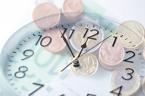 time, business, money making and finance concept - clock over euro coins and banknotes with double exposure effect