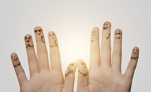 gesture, family, wedding, people and body parts concept - close up of two hands showing fingers with smiley faces