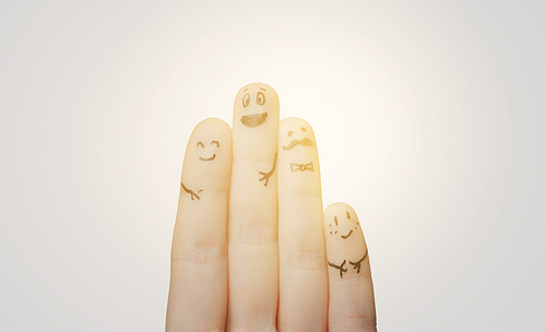 gesture, family, people and body parts concept - close up of two hands showing fingers with smiley faces