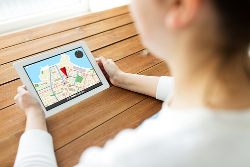 technology, people, navigation and location concept - close up of woman with gps navigator map on tablet pc computer screen on wooden table