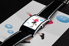 modern technology, sport, object and media concept - close up of black smart watch with fitness application on screen
