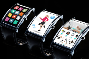 modern technology, object and media concept - close up of black smart watches with applications