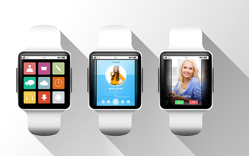 modern technology, object and media concept - close up of black smart watches with applications on screen over gray background