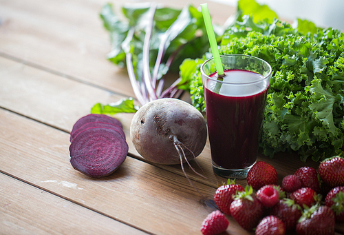 healthy eating, food, dieting and vegetarian concept - glass of beetroot juice, fruits and vegetables on wooden table