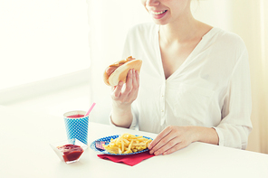 national holidays, celebration, food and patriotism concept - close up of happy woman eating hot dog and french fries with drink in paper cup at 4th july at party on american 독립기념일