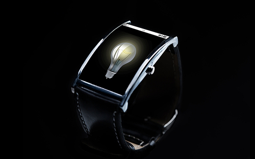 modern technology, idea, object and media concept - close up of black smart watch with light bulb icon on screen