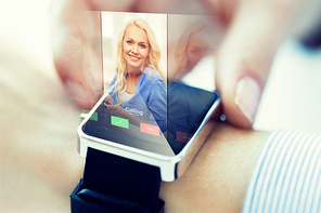 business, communication, technology and people concept - close up of woman hands setting smart watch with incoming call