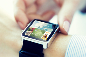 business, technology, mass media and people concept - close up of woman hands setting smart watch with news application