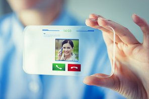 business, technology, communication and people concept - close up of woman hand holding and showing transparent smartphone with incoming video call icon on screen