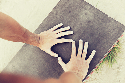 fitness, sport, training and lifestyle concept - close up of male hands exercising on bench outdoors