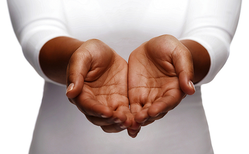 people, charity and poverty concept - close up of african american female empty cupped hands holding and showing something