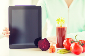 healthy eating, technology, diet and people concept - close up of woman hands with tablet pc, tomato juice and vegetables
