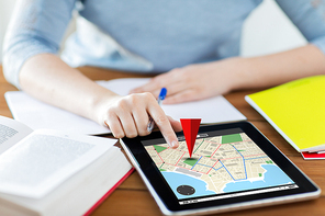 business, location, navigation, technology and internet concept - close up of student woman with gps navigator map on tablet pc computer and notebook at home