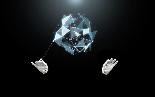 performance, illusion, technology and virtual reality concept - magician hands in gloves with magic wand showing trick with low poly virtual shape over black background