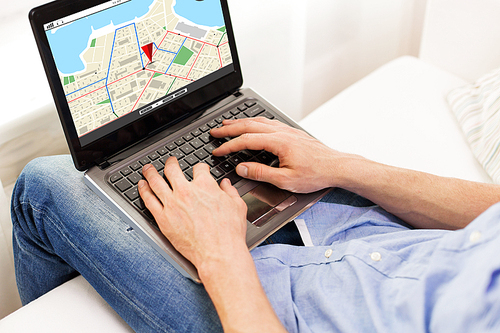 technology, location, navigation, people and lifestyle concept - close up of male hands typing on laptop computer with gps navigator map on screen at home