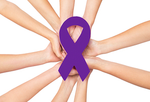 healthcare, charity, people and social problems concept - close up of hands with purple violet domestic violence awareness ribbon over white background
