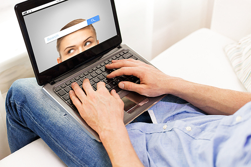 technology, internet, information, people and lifestyle concept - close up of male hands typing on laptop computer with search browser bar on screen at home