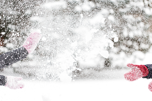 people, season, winter holidays and christmas concept - happy friends playing with snow outdoors