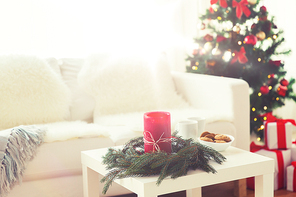 holidays, winter, celebration and still life concept - sofa, table and christmas tree with gifts at home